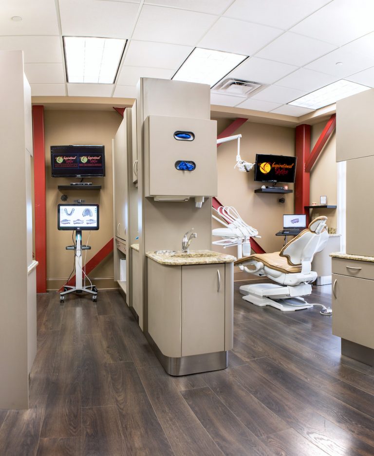 The image shows an interior view of a dental office with modern equipment and a well-organized layout.