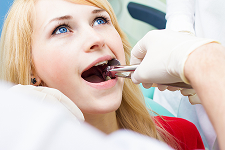 A woman receiving dental treatment with a dentist performing the procedure, captured in a split-screen format, emphasizing the dental care being provided.